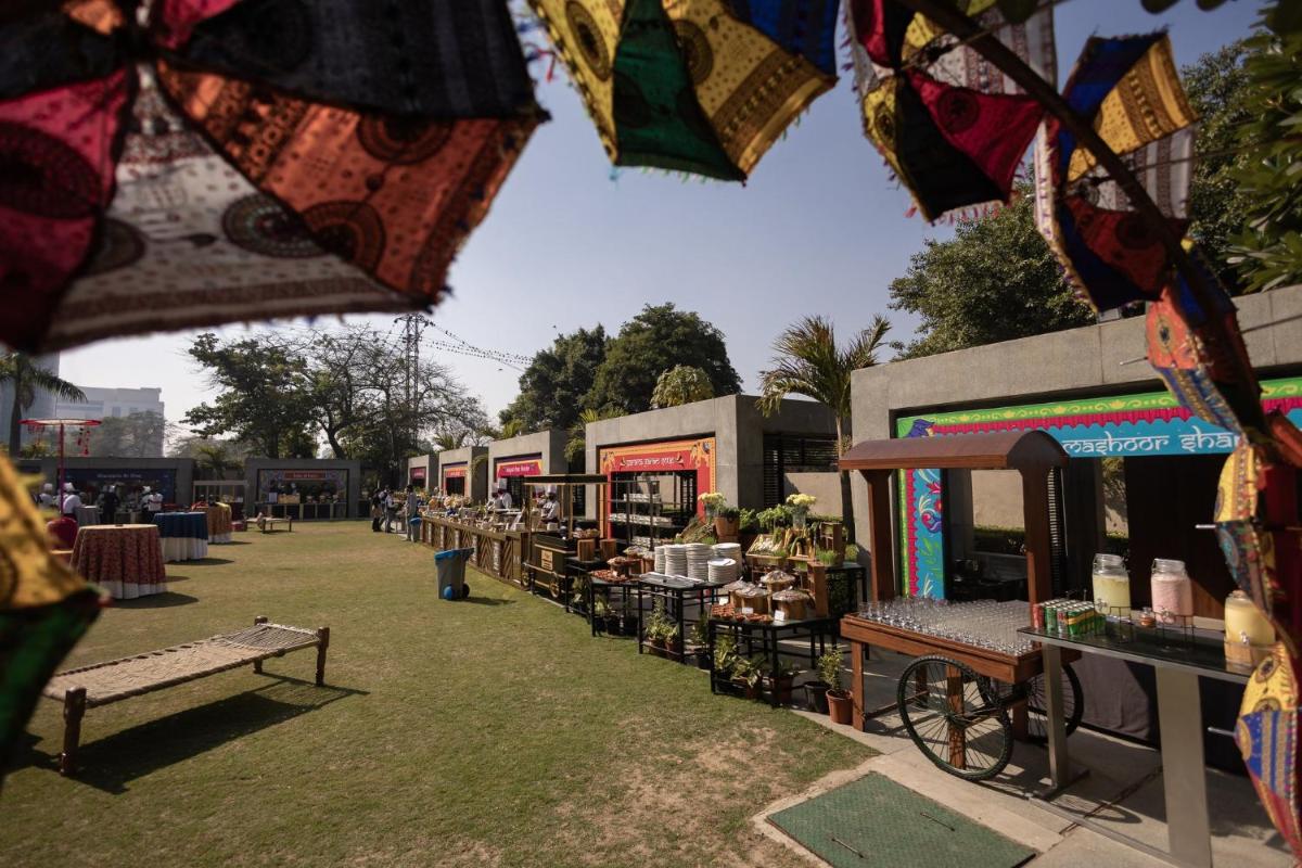 a row of food trucks parked in a field at Crowne Plaza Today Gurugram by IHG in Gurgaon
