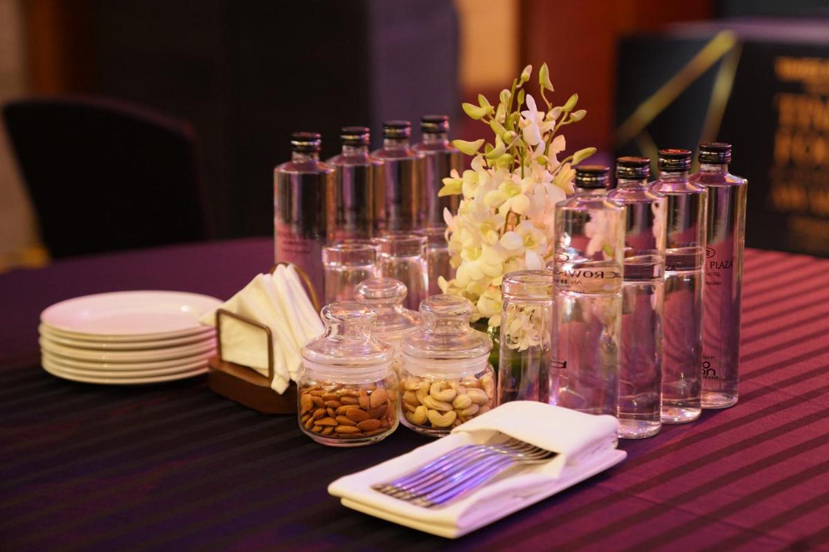 a table with jars and a vase filled with food at Crowne Plaza Today Gurugram by IHG in Gurgaon