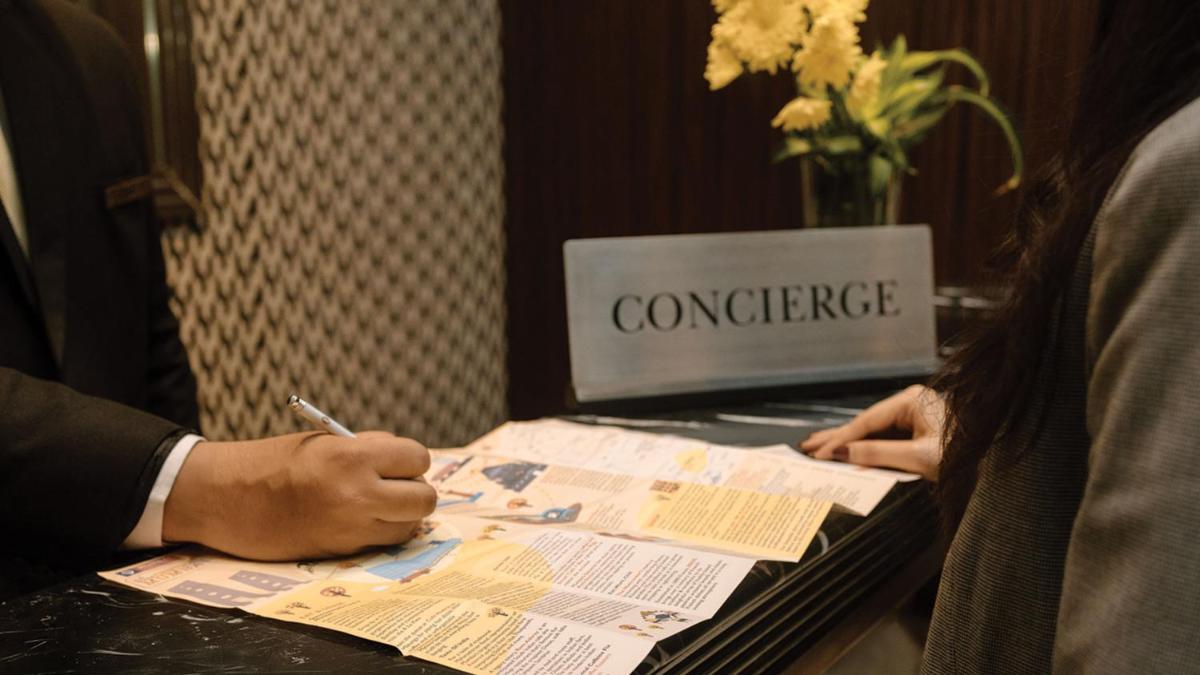 a person sitting at a table with a laptop at InterContinental Marine Drive Mumbai by IHG in Mumbai