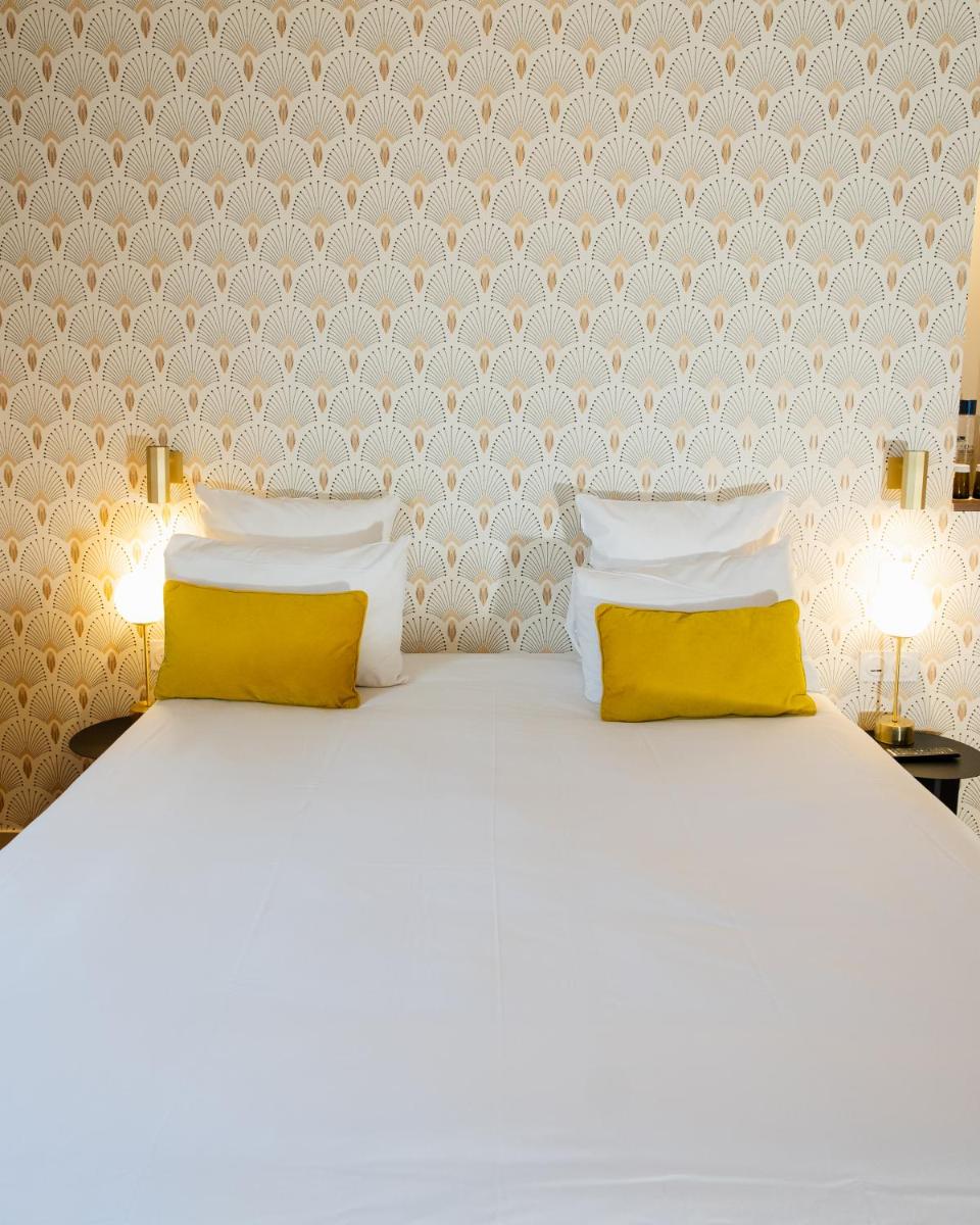 Un ou plusieurs lits dans un hébergement de l'établissement Hôtel Artemisia Montmartre