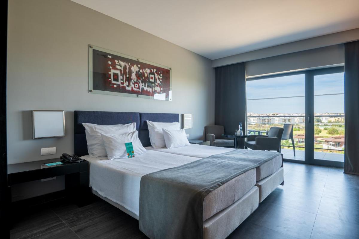 Uma cama ou camas num quarto em Vila Gale Lagos