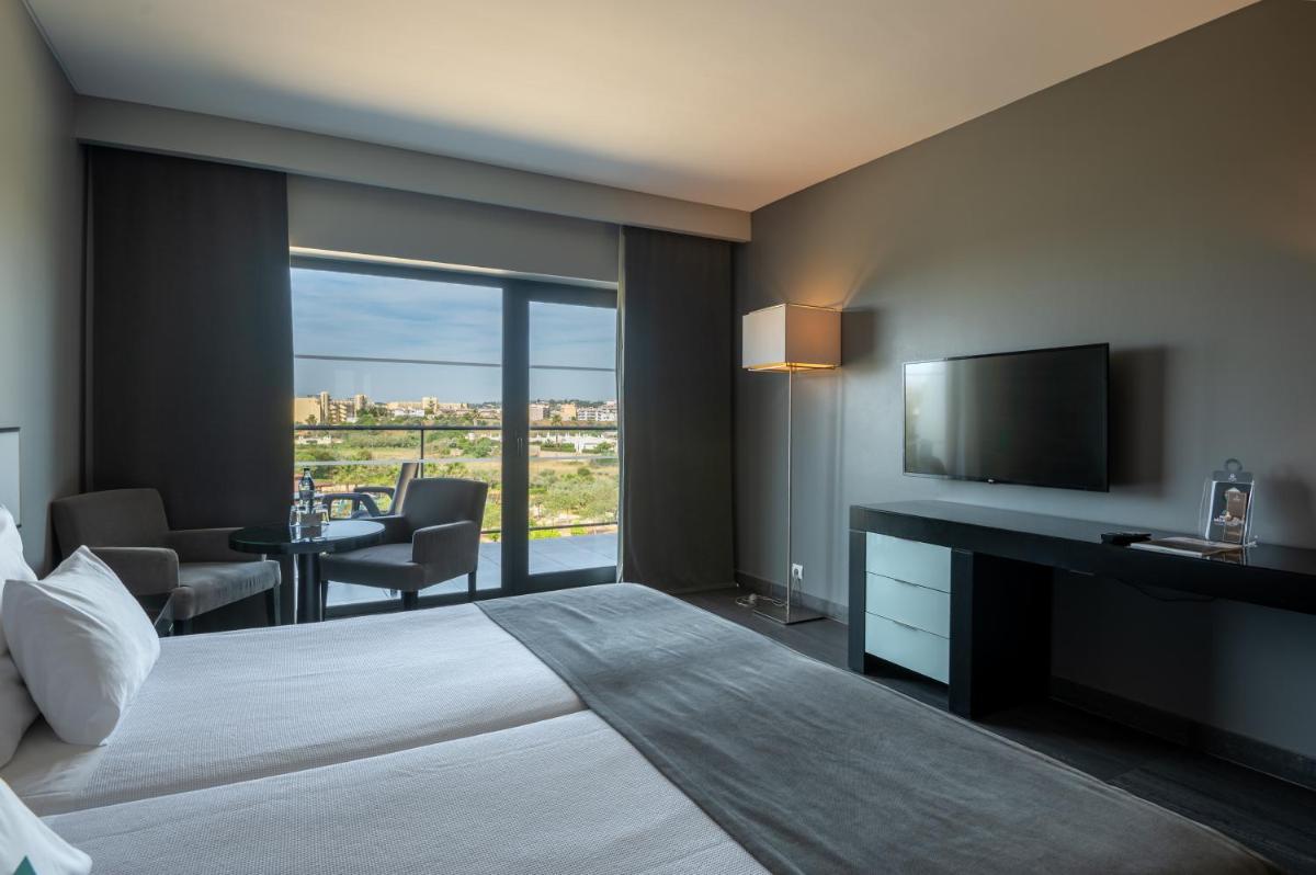 Uma cama ou camas num quarto em Vila Gale Lagos