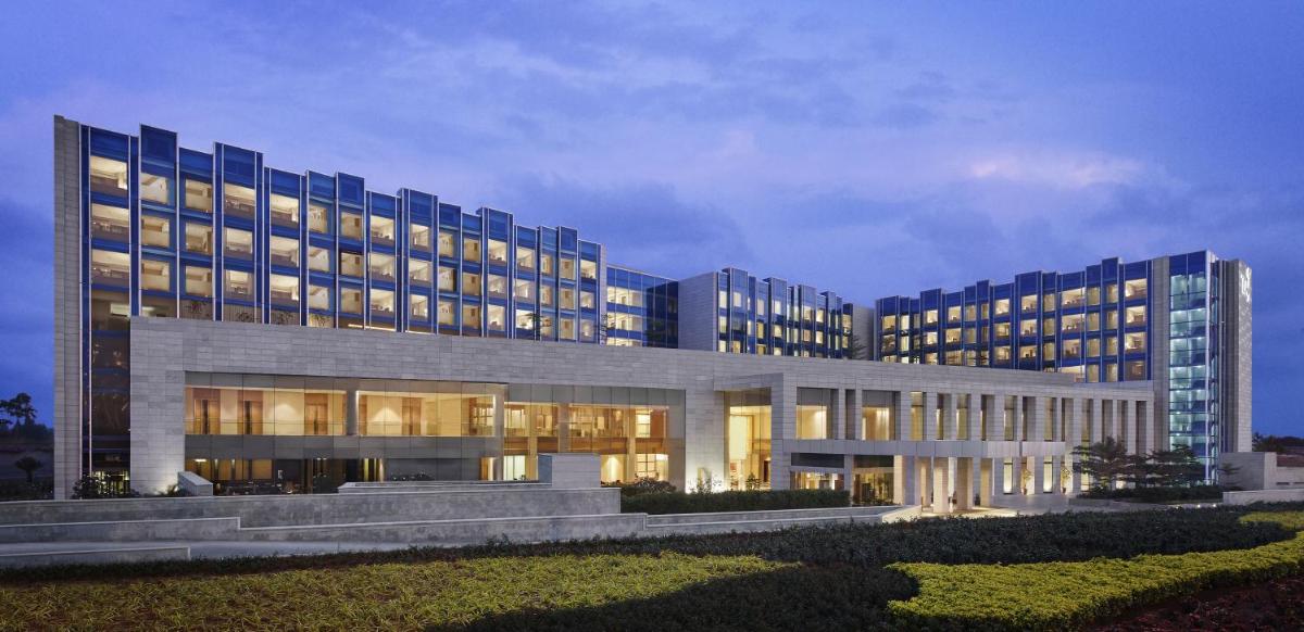 a large building with lights on in front of it at Taj Bangalore in Devanahalli-Bangalore