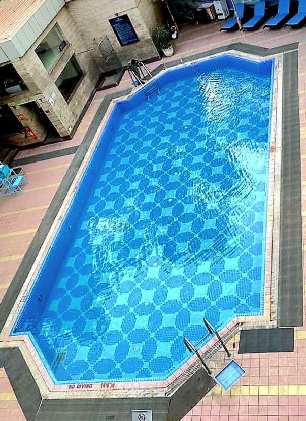 an overhead view of a large blue swimming pool at Jaypee Siddharth in New Delhi an overhead view of a large blue swimming pool at Jaypee Siddharth in New Delhi