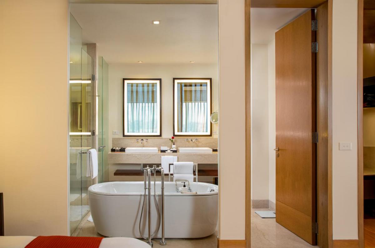 a bathroom with a bath tub and a sink at Trident Hyderabad in Hyderabad
