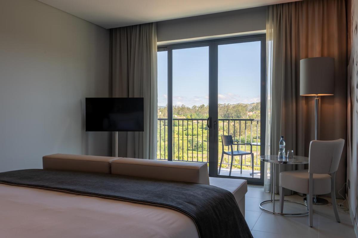Uma cama ou camas num quarto em Vila Gale Collection Ponte de Lima