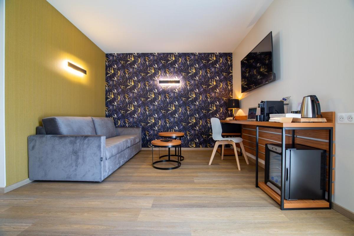 Télévision ou salle de divertissement dans l'établissement Best Western Côte des Sables Plouescat