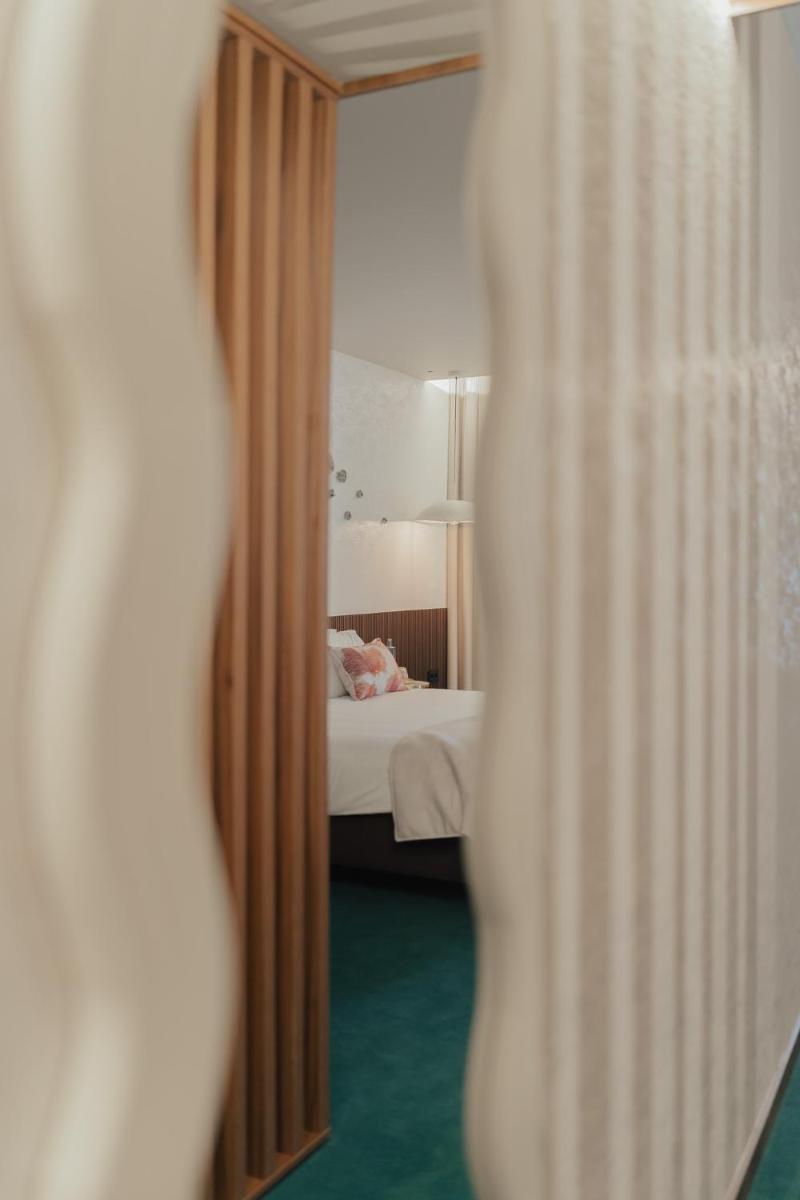 Uma cama ou camas num quarto em Hotel Leiriartem by Grupo Quinta dos Lagos
