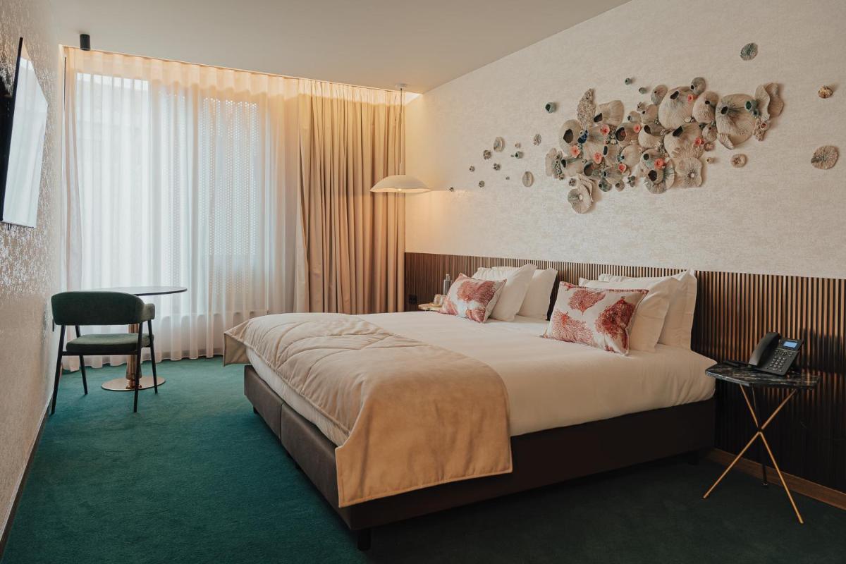 Uma cama ou camas num quarto em Hotel Leiriartem by Grupo Quinta dos Lagos
