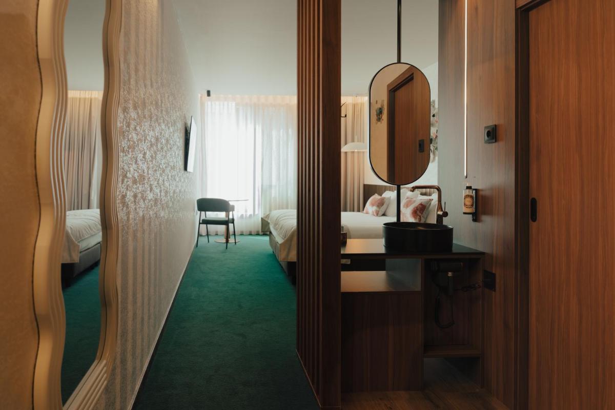 Uma cama ou camas num quarto em Hotel Leiriartem by Grupo Quinta dos Lagos