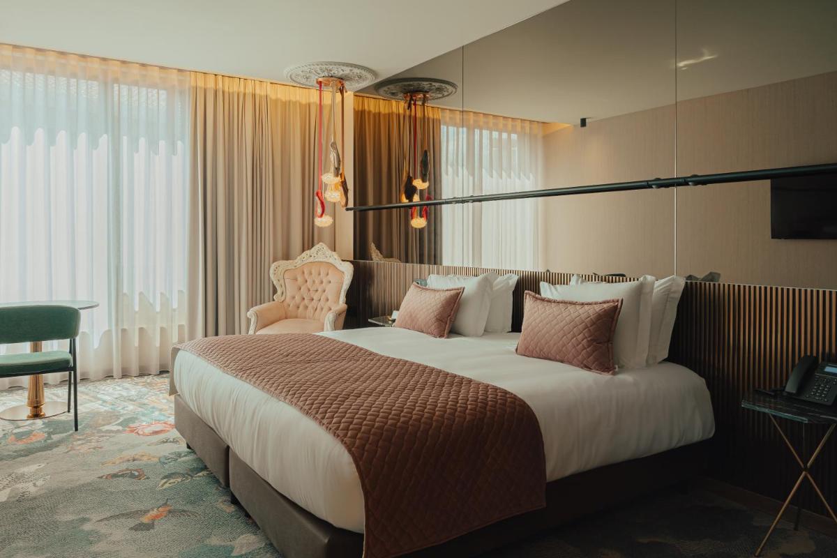 Uma cama ou camas num quarto em Hotel Leiriartem by Grupo Quinta dos Lagos