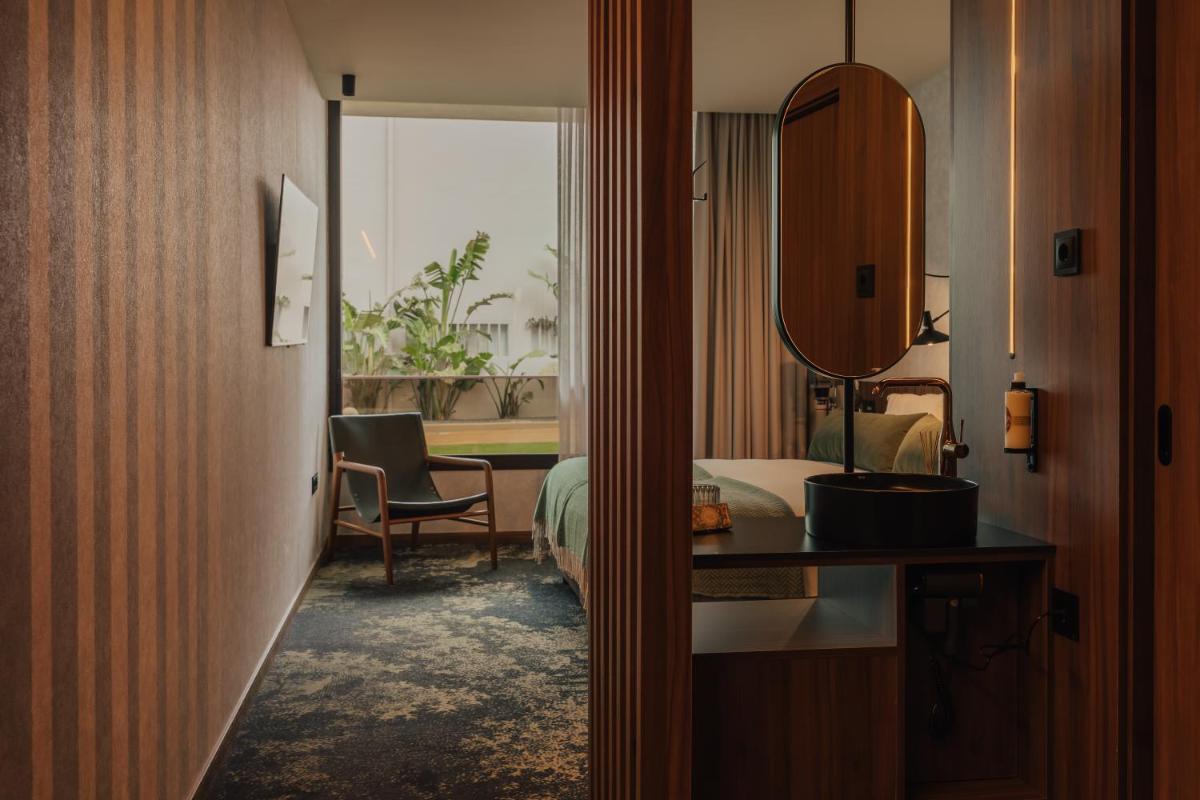Uma cama ou camas num quarto em Hotel Leiriartem by Grupo Quinta dos Lagos
