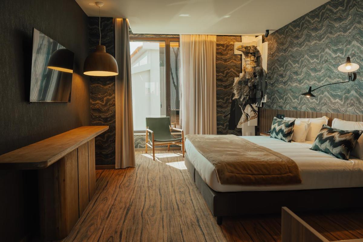 Uma cama ou camas num quarto em Hotel Leiriartem by Grupo Quinta dos Lagos