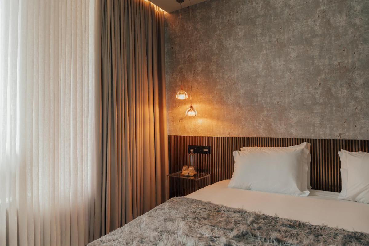 Uma cama ou camas num quarto em Hotel Leiriartem by Grupo Quinta dos Lagos