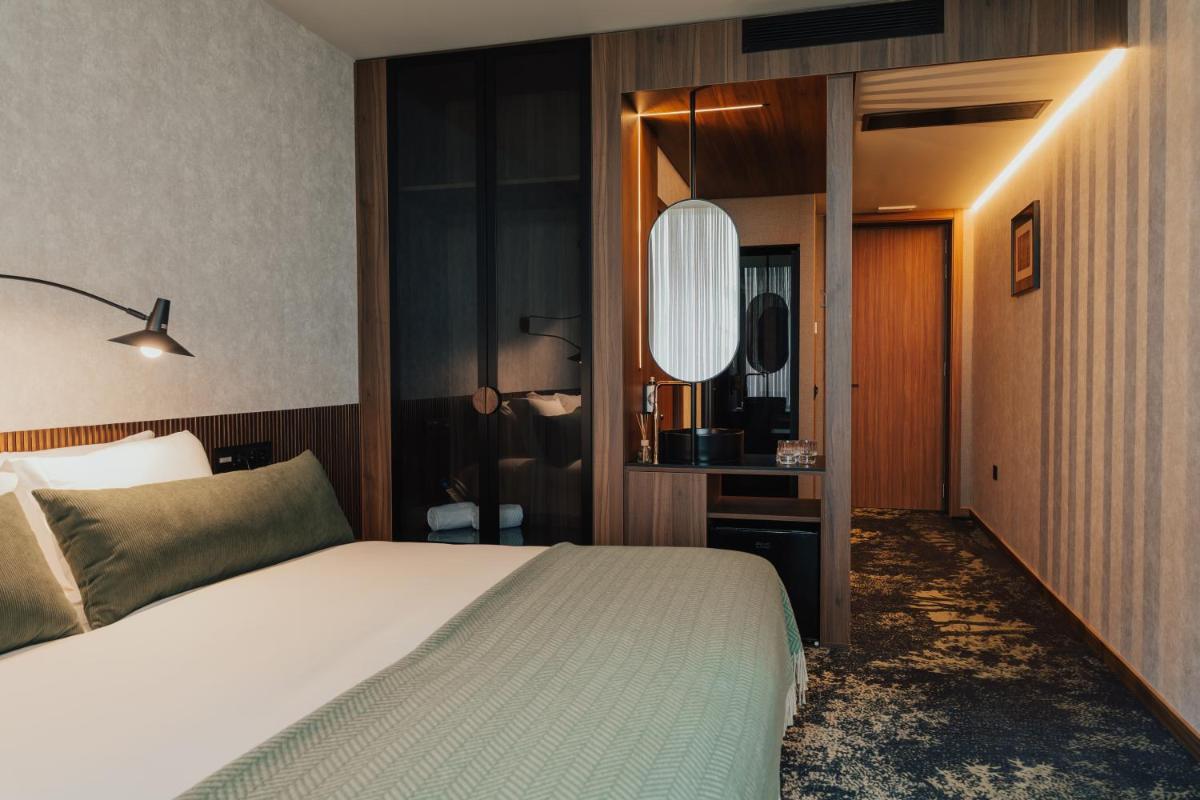 Uma cama ou camas num quarto em Hotel Leiriartem by Grupo Quinta dos Lagos