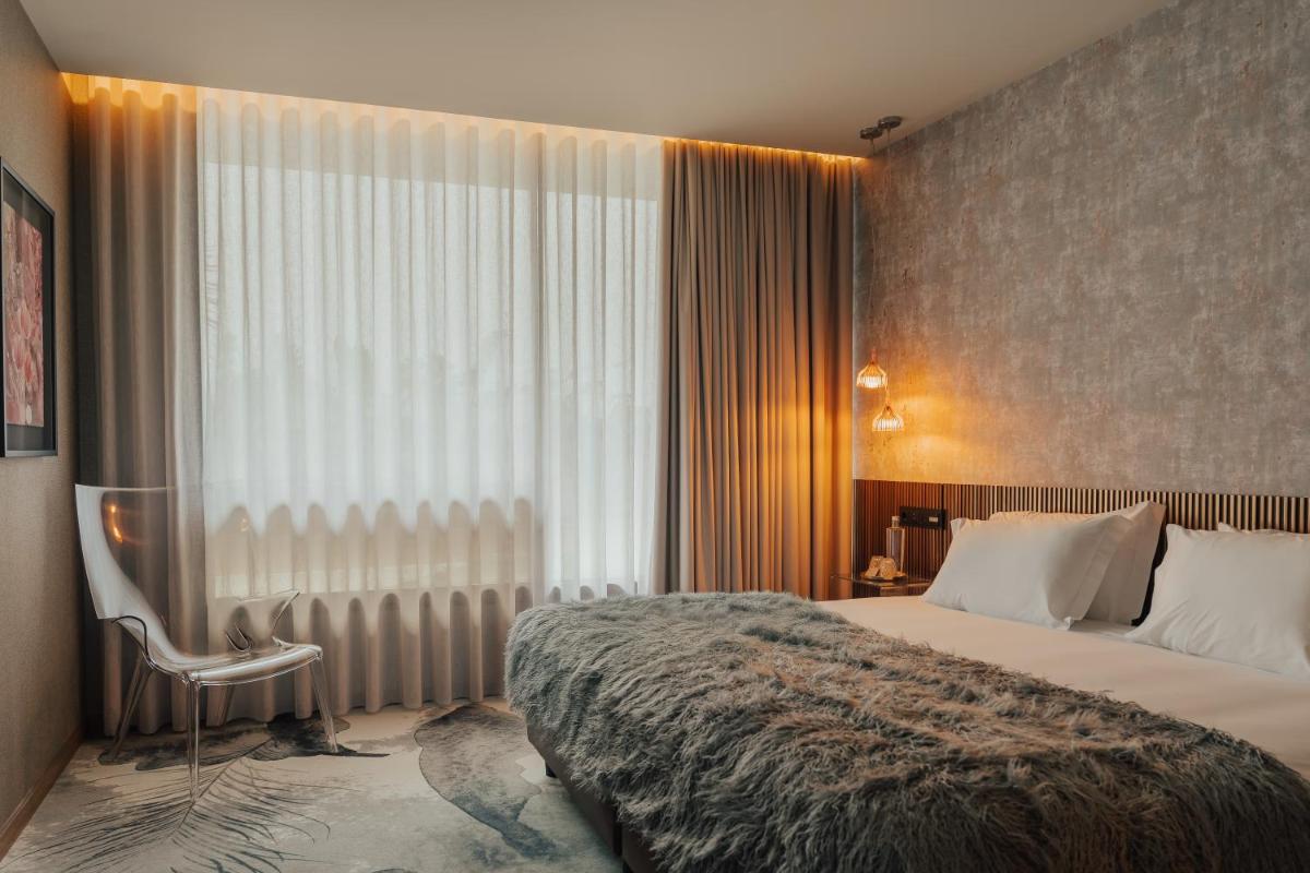 Uma cama ou camas num quarto em Hotel Leiriartem by Grupo Quinta dos Lagos