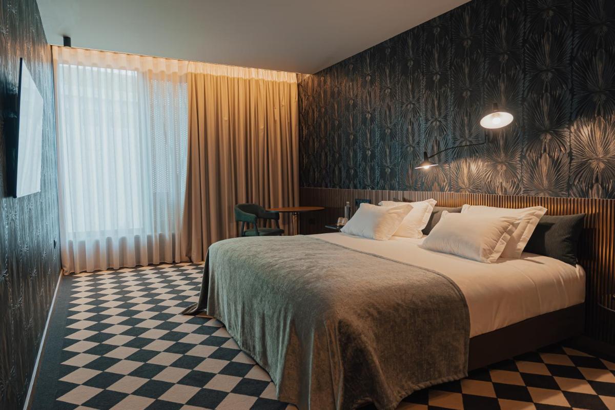 Uma cama ou camas num quarto em Hotel Leiriartem by Grupo Quinta dos Lagos