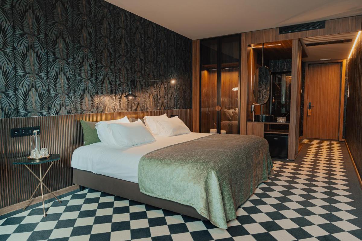Uma cama ou camas num quarto em Hotel Leiriartem by Grupo Quinta dos Lagos