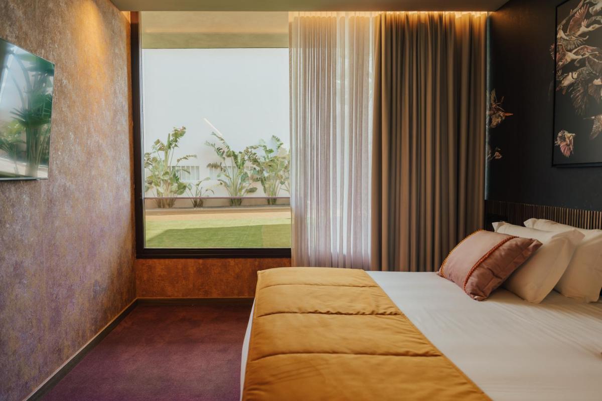 Uma cama ou camas num quarto em Hotel Leiriartem by Grupo Quinta dos Lagos