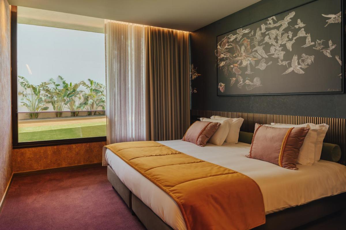 Uma cama ou camas num quarto em Hotel Leiriartem by Grupo Quinta dos Lagos