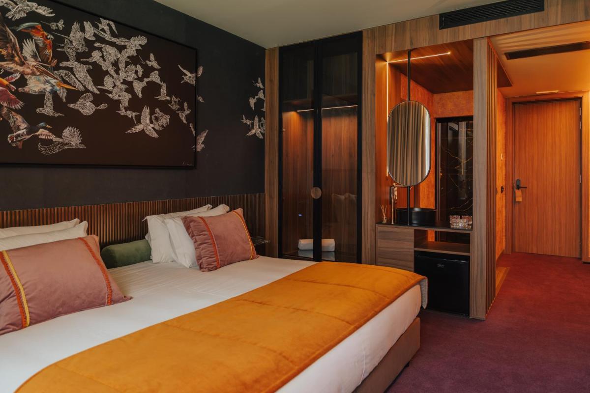 Uma cama ou camas num quarto em Hotel Leiriartem by Grupo Quinta dos Lagos