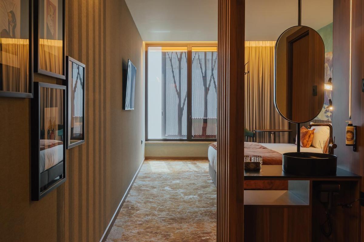 Uma cama ou camas num quarto em Hotel Leiriartem by Grupo Quinta dos Lagos