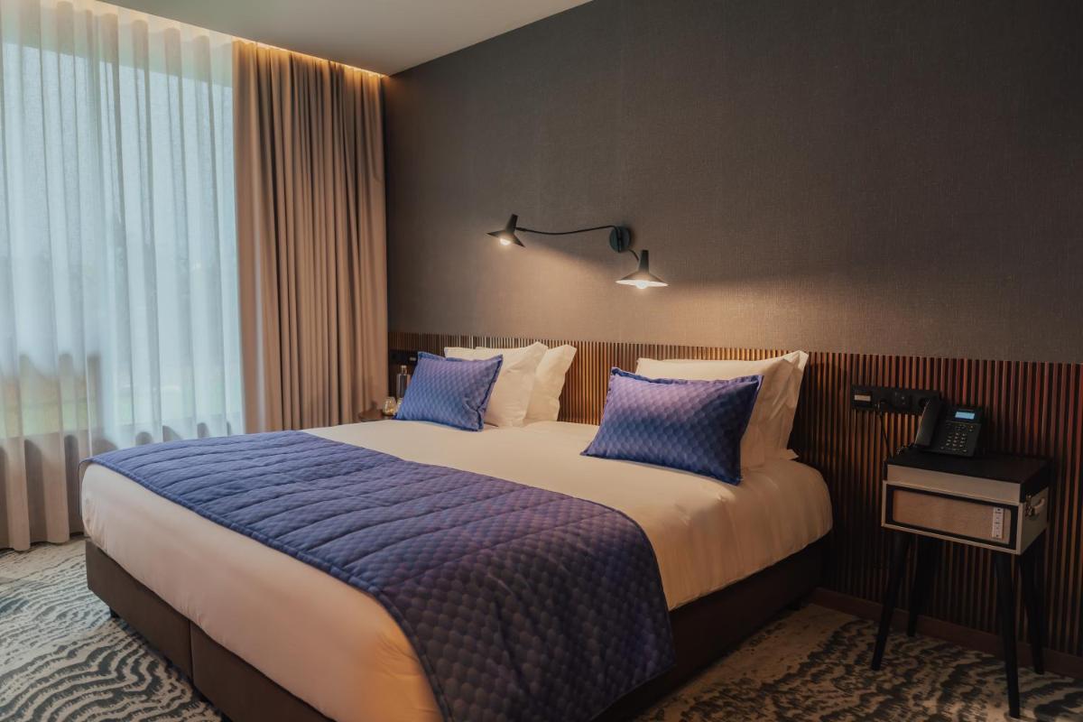 Uma cama ou camas num quarto em Hotel Leiriartem by Grupo Quinta dos Lagos