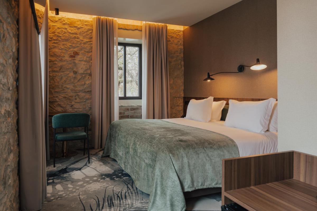 Uma cama ou camas num quarto em Hotel Leiriartem by Grupo Quinta dos Lagos