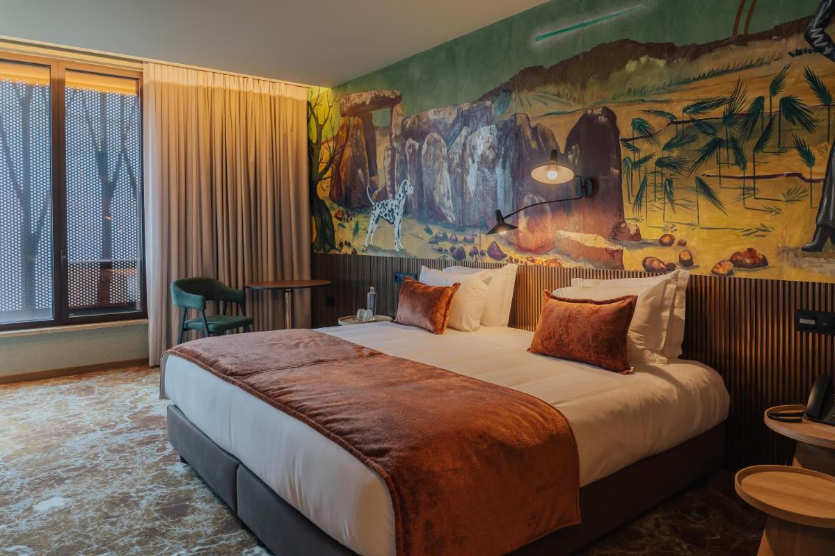 Uma cama ou camas num quarto em Hotel Leiriartem by Grupo Quinta dos Lagos