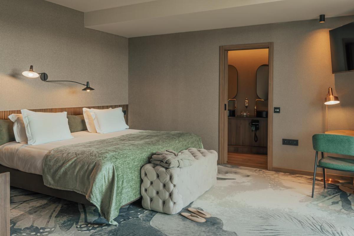 Uma cama ou camas num quarto em Hotel Leiriartem by Grupo Quinta dos Lagos