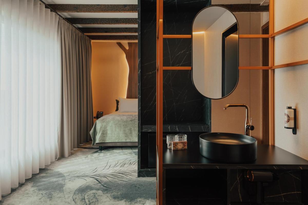 Uma cama ou camas num quarto em Hotel Leiriartem by Grupo Quinta dos Lagos