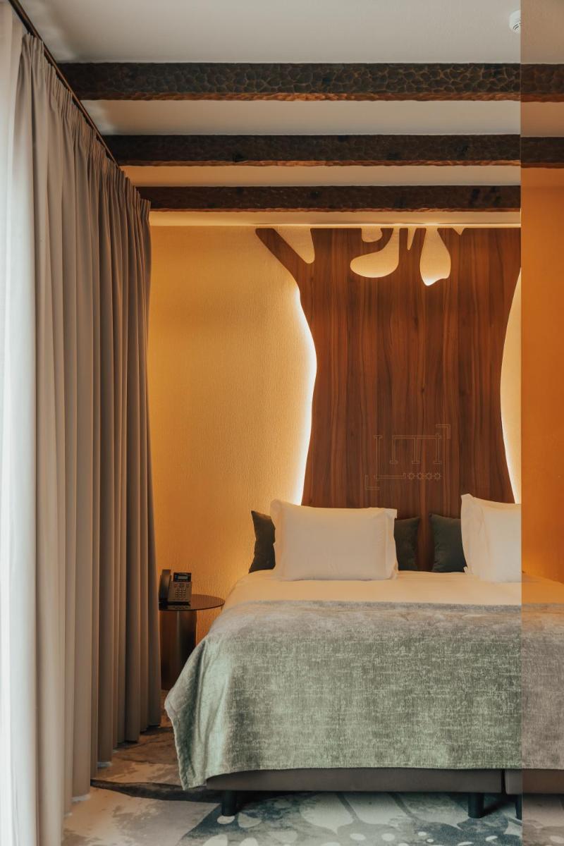 Uma cama ou camas num quarto em Hotel Leiriartem by Grupo Quinta dos Lagos