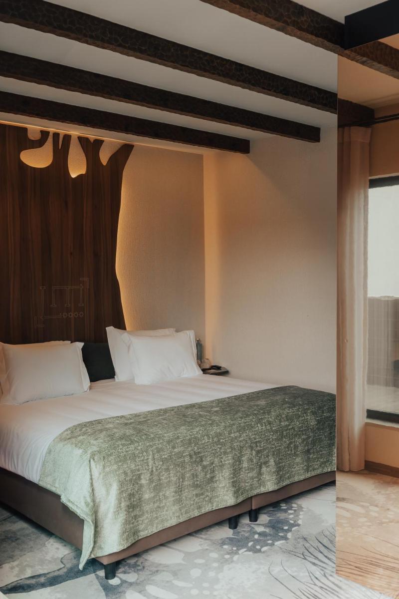 Uma cama ou camas num quarto em Hotel Leiriartem by Grupo Quinta dos Lagos
