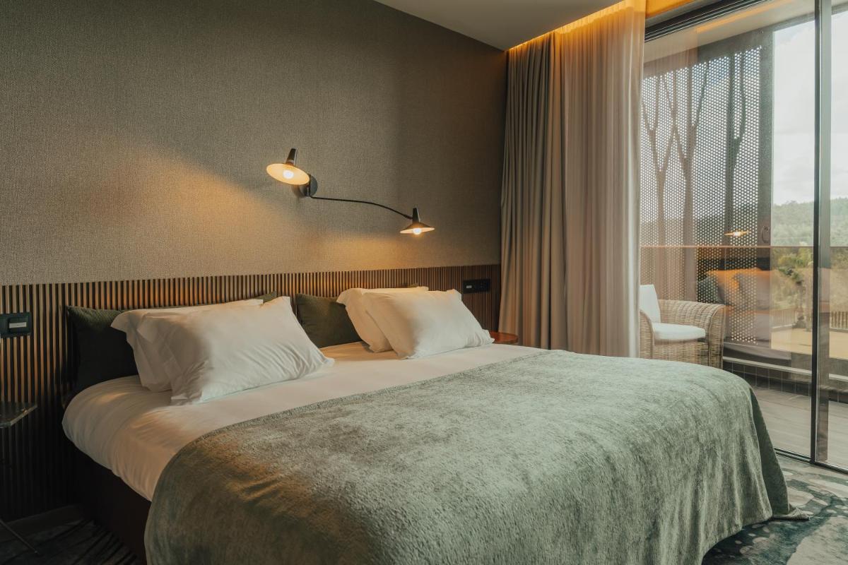 Uma cama ou camas num quarto em Hotel Leiriartem by Grupo Quinta dos Lagos