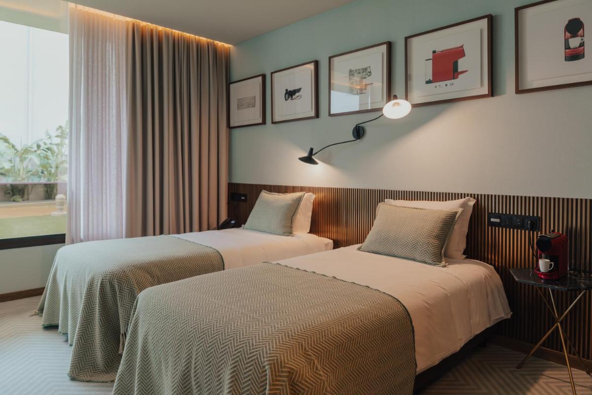 Uma cama ou camas num quarto em Hotel Leiriartem by Grupo Quinta dos Lagos