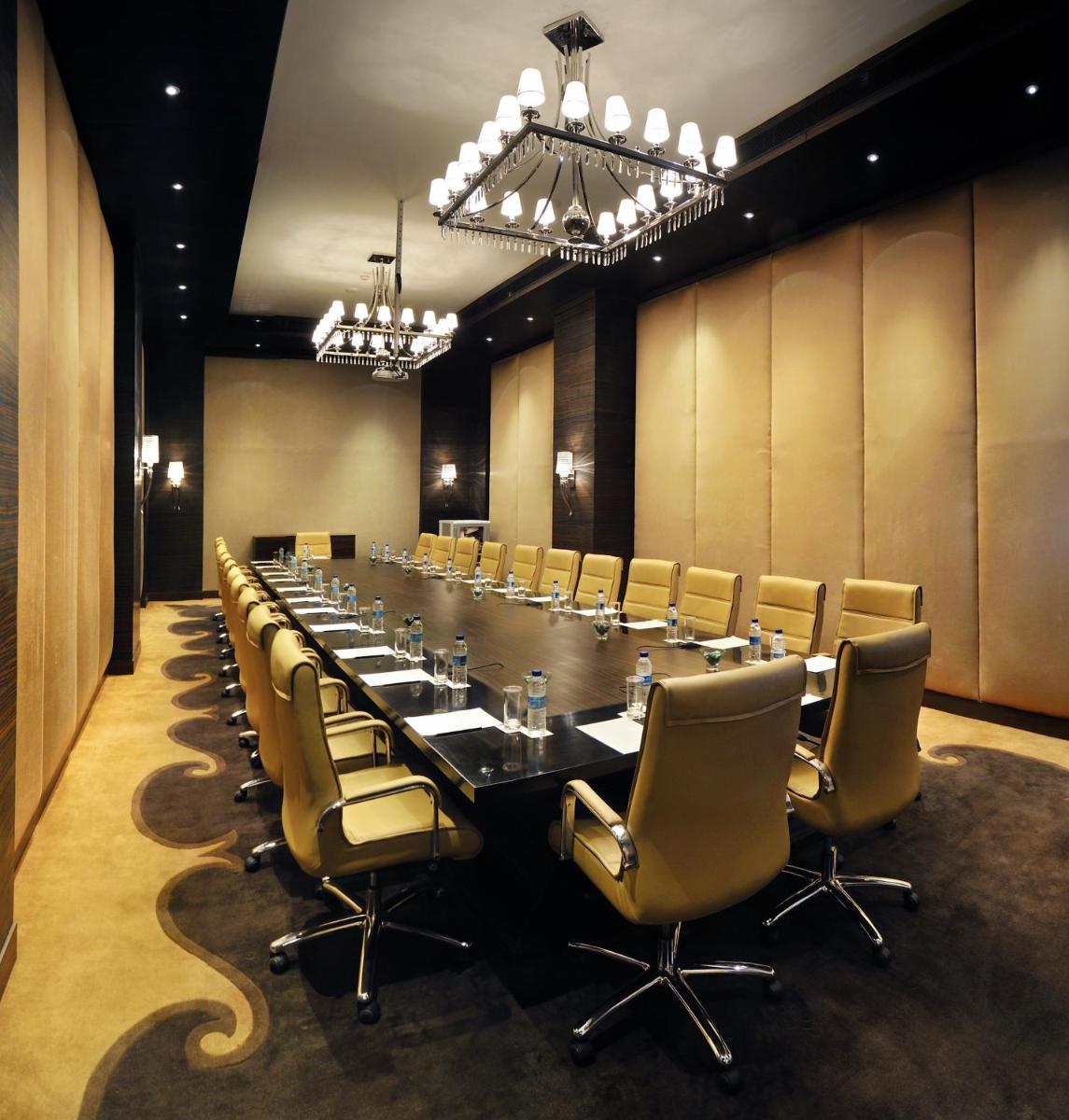 a large conference room with a long table and chairs at Radisson Blu Hotel New Delhi Paschim Vihar in New Delhi a large conference room with a long table and chairs at Radisson Blu Hotel New Delhi Paschim Vihar in New Delhi