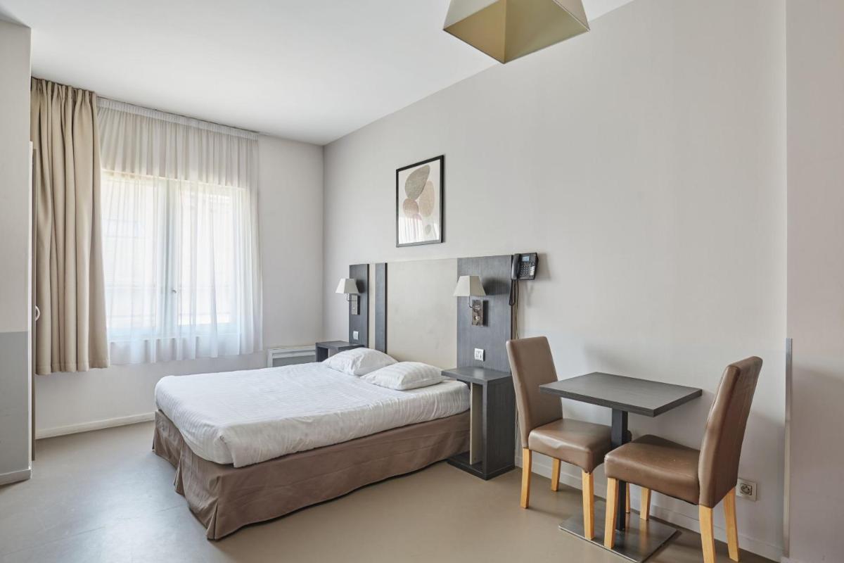 Un ou plusieurs lits dans un hébergement de l'établissement Appart'hôtel Odalys City - Dijon Centre Les Cordeliers