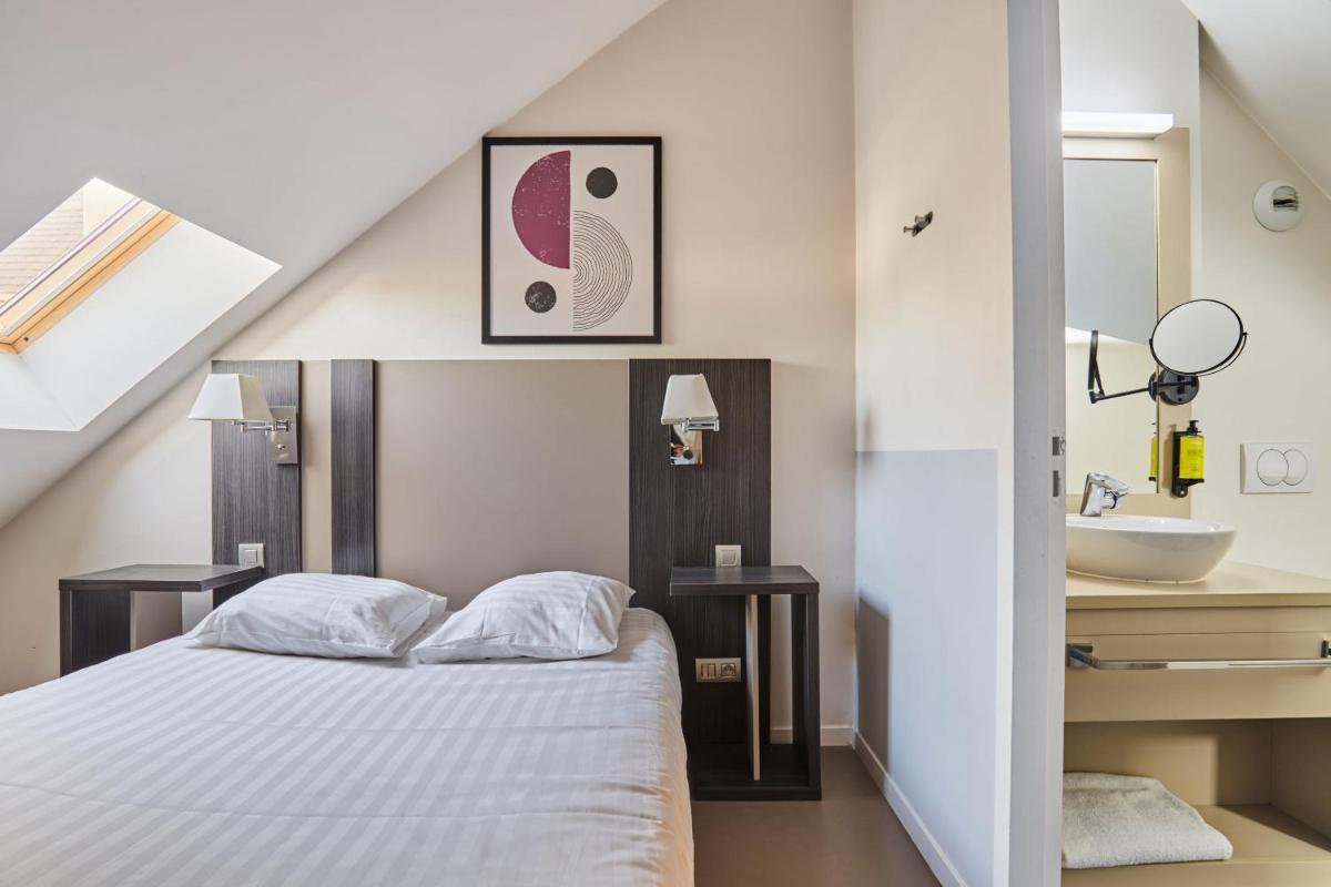 Un ou plusieurs lits dans un hébergement de l'établissement Appart'hôtel Odalys City - Dijon Centre Les Cordeliers