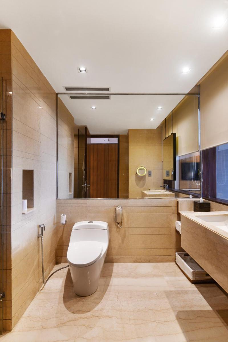 a bathroom with a toilet and a sink at Hyatt Ahmedabad in Ahmedabad