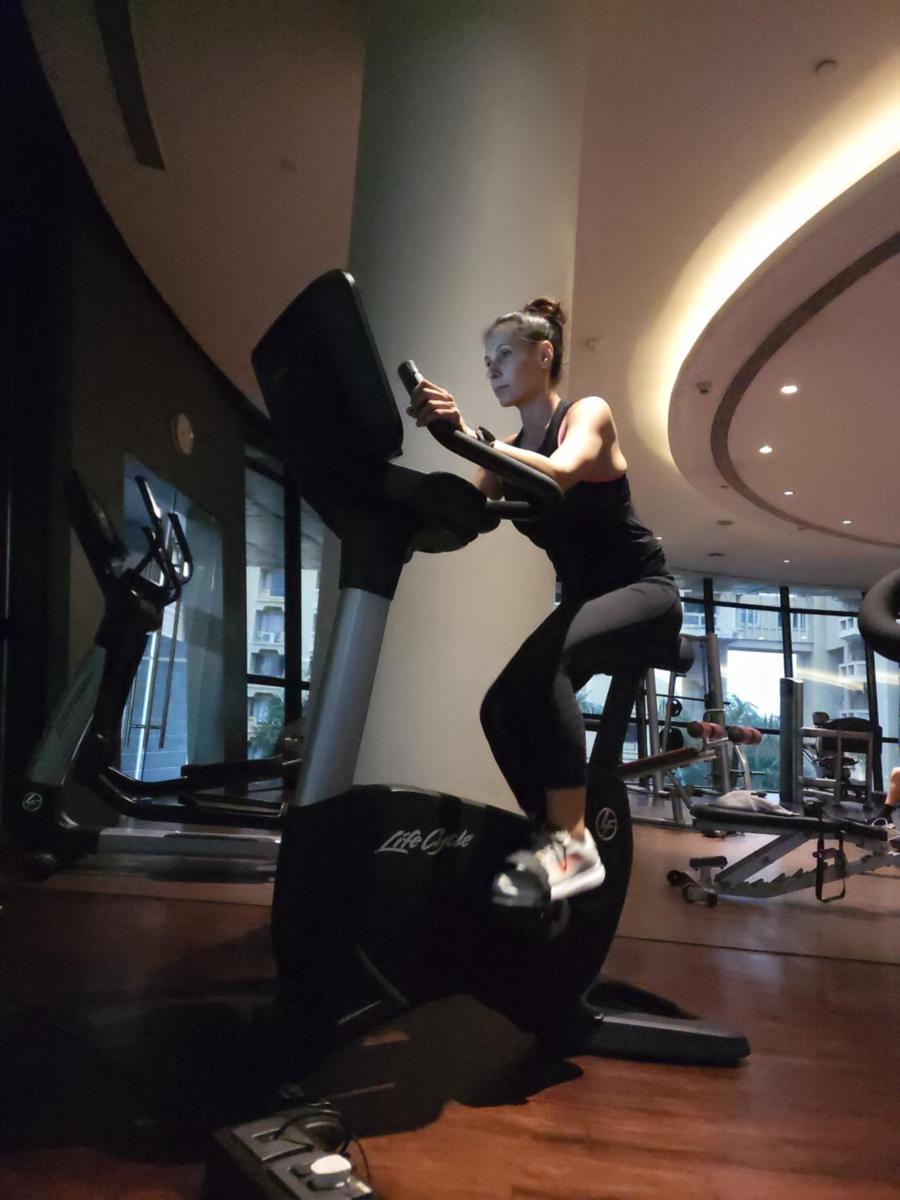 a woman on an exercise bike in a gym at Marriott Suites Pune in Pune