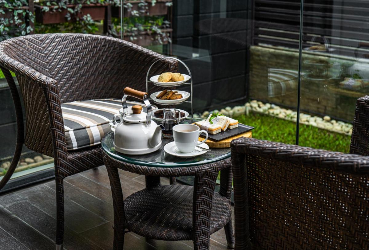 a table with a tray of food on a patio at Marriott Suites Pune in Pune