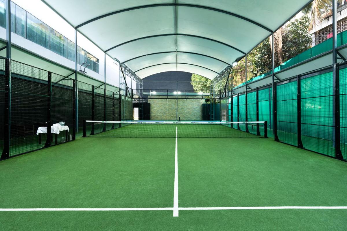 a tennis court in a building with a tennis at Marriott Suites Pune in Pune
