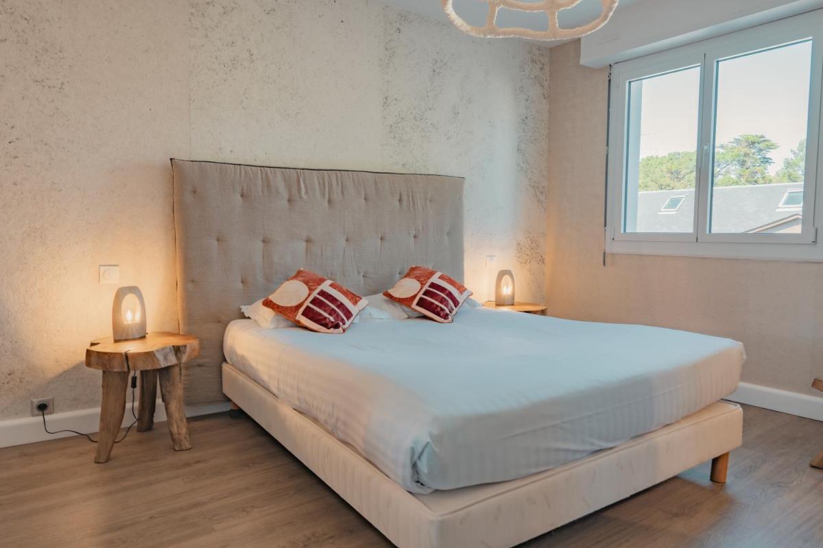 Un ou plusieurs lits dans un hébergement de l'établissement Hôtel Édenia - Spa Estime&Sens
