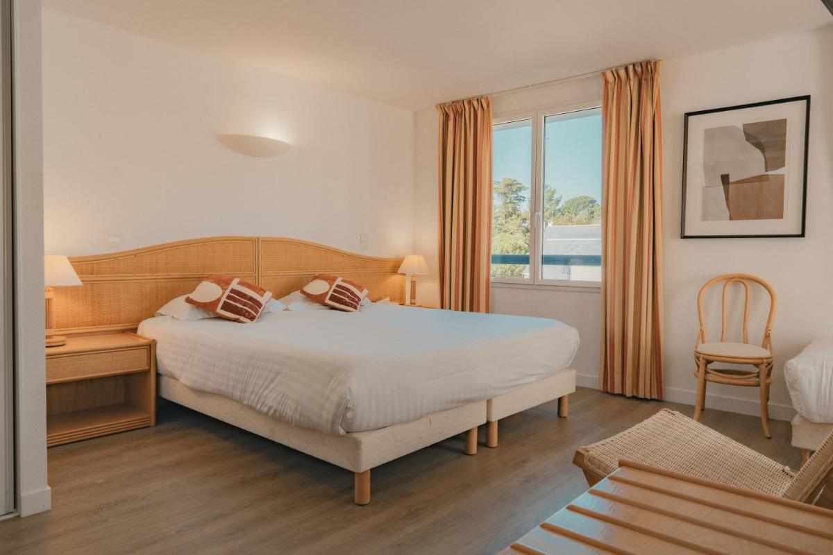 Un ou plusieurs lits dans un hébergement de l'établissement Hôtel Édenia - Spa Estime&Sens