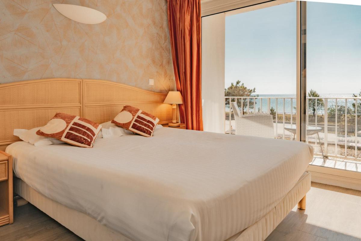 Un ou plusieurs lits dans un hébergement de l'établissement Hôtel Édenia - Spa Estime&Sens