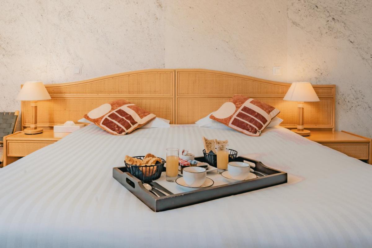 Un ou plusieurs lits dans un hébergement de l'établissement Hôtel Édenia - Spa Estime&Sens