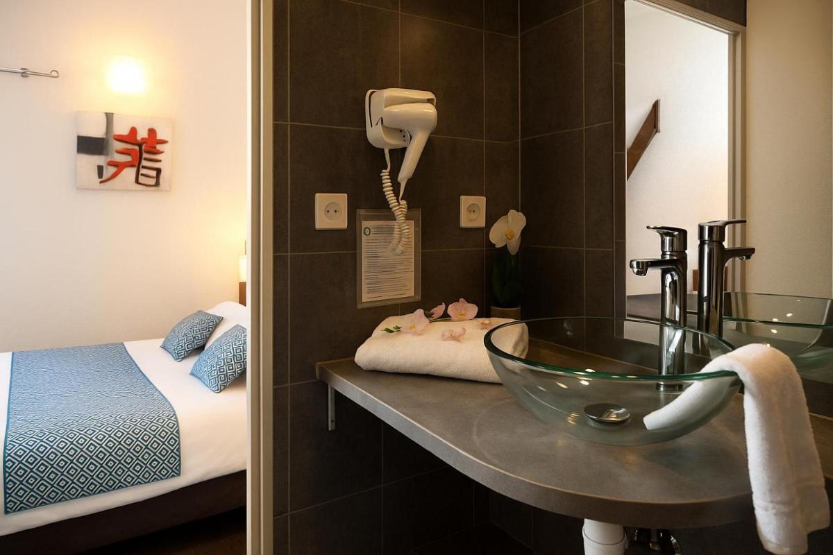 Un ou plusieurs lits dans un hébergement de l'établissement Hotel & Spa Gil de France Cap d'Agde