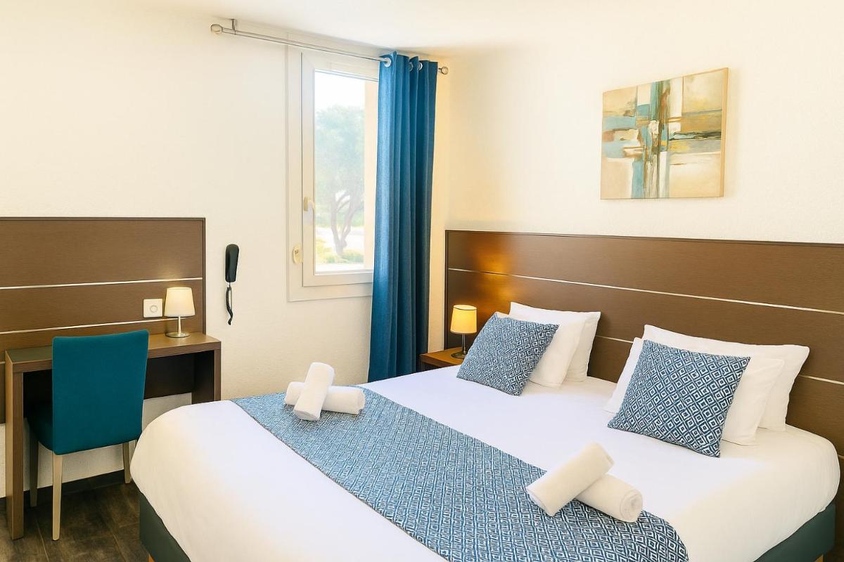 Un ou plusieurs lits dans un hébergement de l'établissement Hotel & Spa Gil de France Cap d'Agde