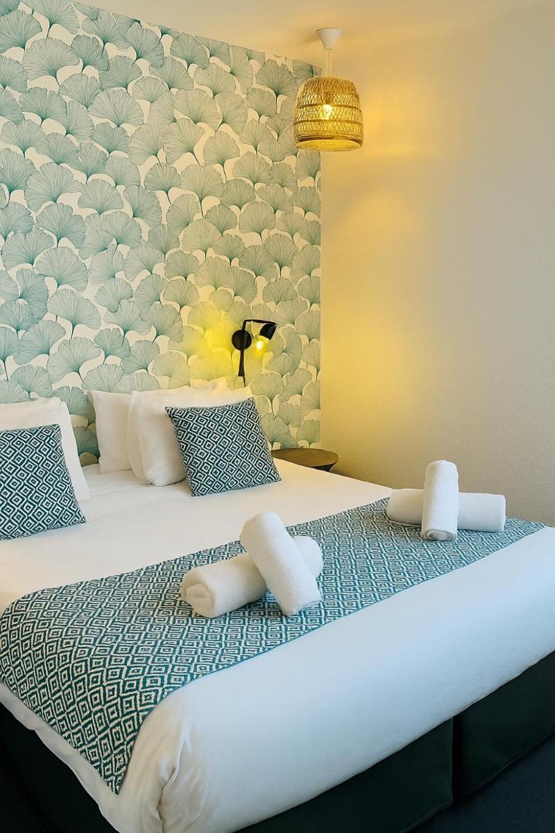 Un ou plusieurs lits dans un hébergement de l'établissement Hotel & Spa Gil de France Cap d'Agde