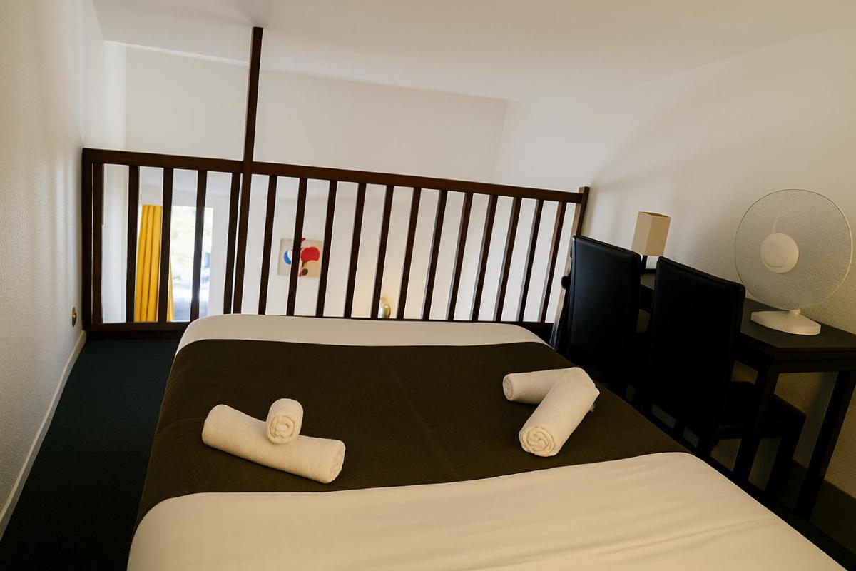 Un ou plusieurs lits dans un hébergement de l'établissement Hotel & Spa Gil de France Cap d'Agde